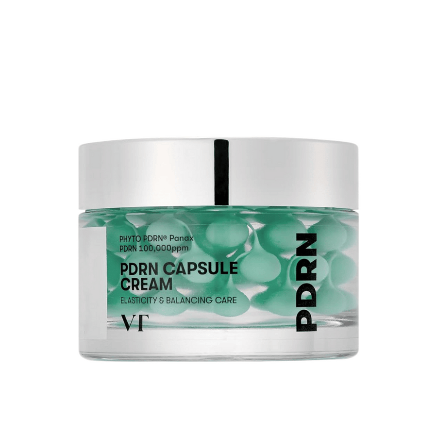 VT PDRN Capsule Cream i en transparent burk med silverlock. Innehållet består av gröna kapslar i en klar gel, och etiketten visar att krämen är avsedd för elasticitet och balanserande hudvård.