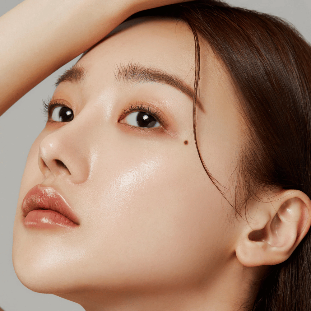 Närbild på hud med lyster – resultatet av Medicube Deep Lifting Peptide Eye Cream som stärker hudens elasticitet och återfuktar.
