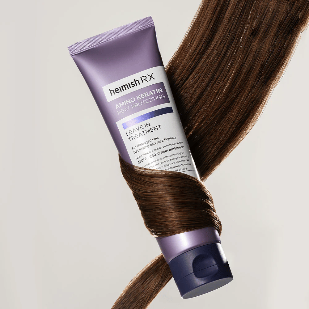 Heimish RX Amino Keratin Leave-In Treatment – näringsrik värmeskyddande hårbehandling omgiven av glansigt hår, symboliserar stärkande och återfuktande effekt för skadat hår.