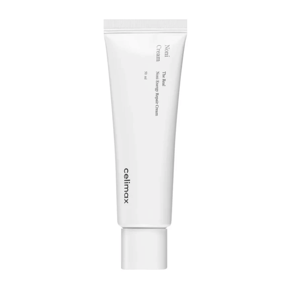 Celimax Noni Energy Repair Cream in einer weißen Tube mit schwarzem Text. Das Produkt ist als "The Real Noni Energy Repair Cream" gekennzeichnet und hat ein Volumen von 50 ml.