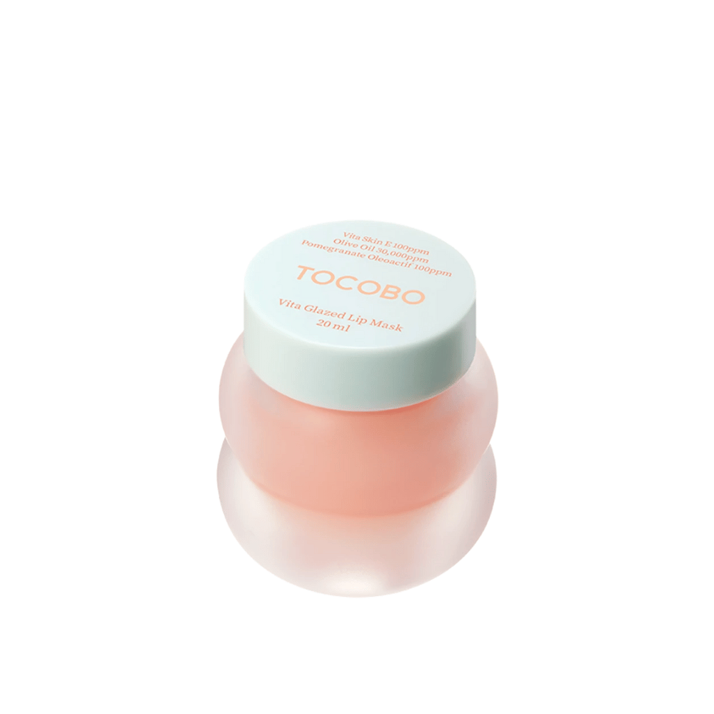 Ein Glas mit "Vita Glazed Lip Mask" von Tocobo wird angezeigt. Das Glas ist rund und durchsichtig mit einem helltürkisen Deckel. Die Maske im Inneren ist hellrosa und dafür konzipiert, die Lippen mit Feuchtigkeit zu versorgen und zu pflegen. Das Produkt hat ein Volumen von 20 ml.
